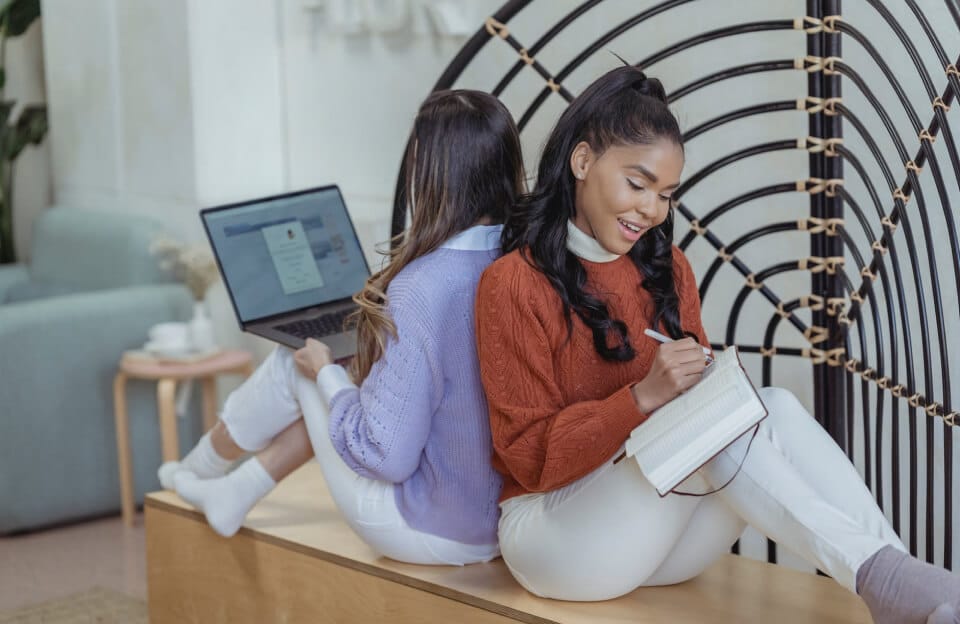 woman with book and laptop