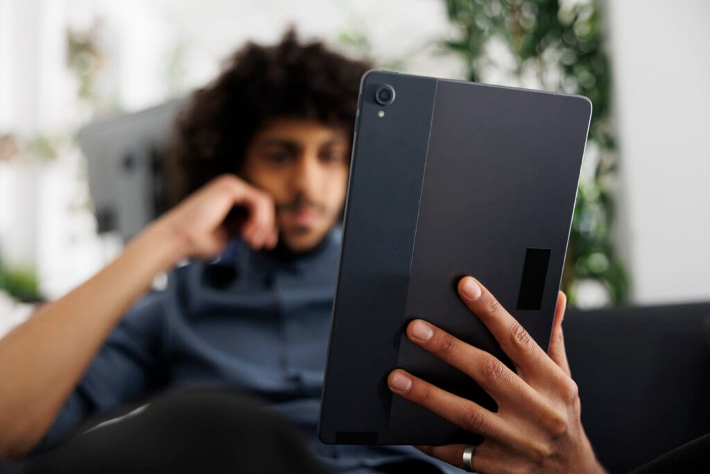 Young arab entrepreneur reading article on digital tablet